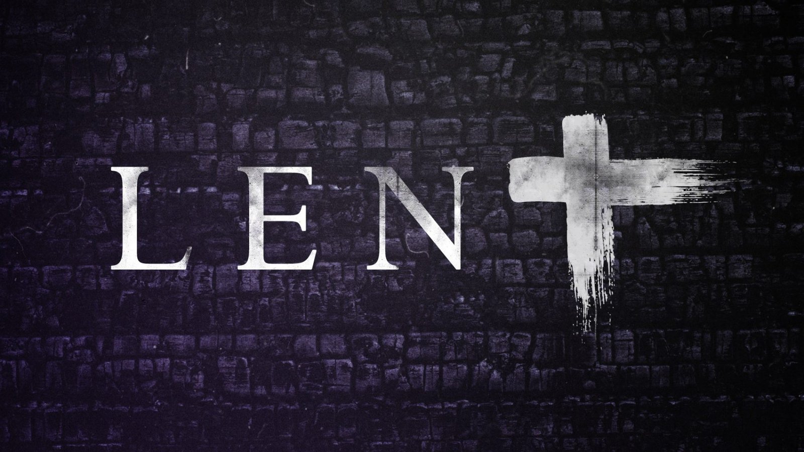 'Lent' in white lettering on a dark stone wall, with a white cross to the right.