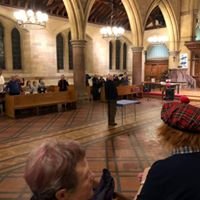 Rob and Margaret North bid farewell in a church setting with attendees.