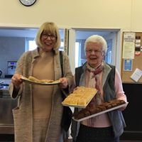 Rob and Margaret North's farewell: two women with trays of baked goods