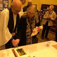 Rob and Margaret North cut a cake at their farewell celebration