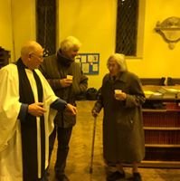 Rob and Margaret North say farewell, with a clergyman present.