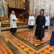 Clergy in robes in a church during COVID-19 pandemic worship resources.