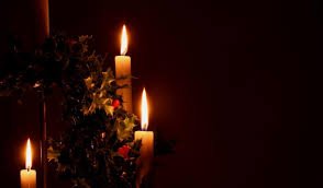 Candles and holly at a Lessons and Carols service