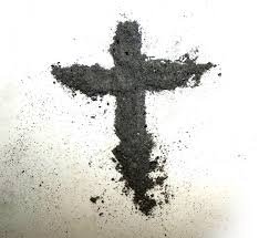 Ash Wednesday ashes in a cross shape on white background