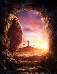 Easter Sunday sunrise over three crosses, viewed from inside an empty tomb