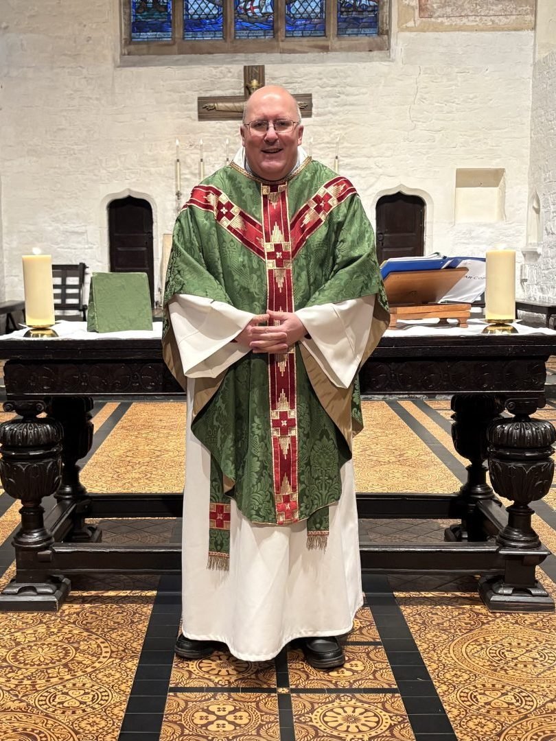 Priest in vestments stands at the altar in All Saints, Hereford.